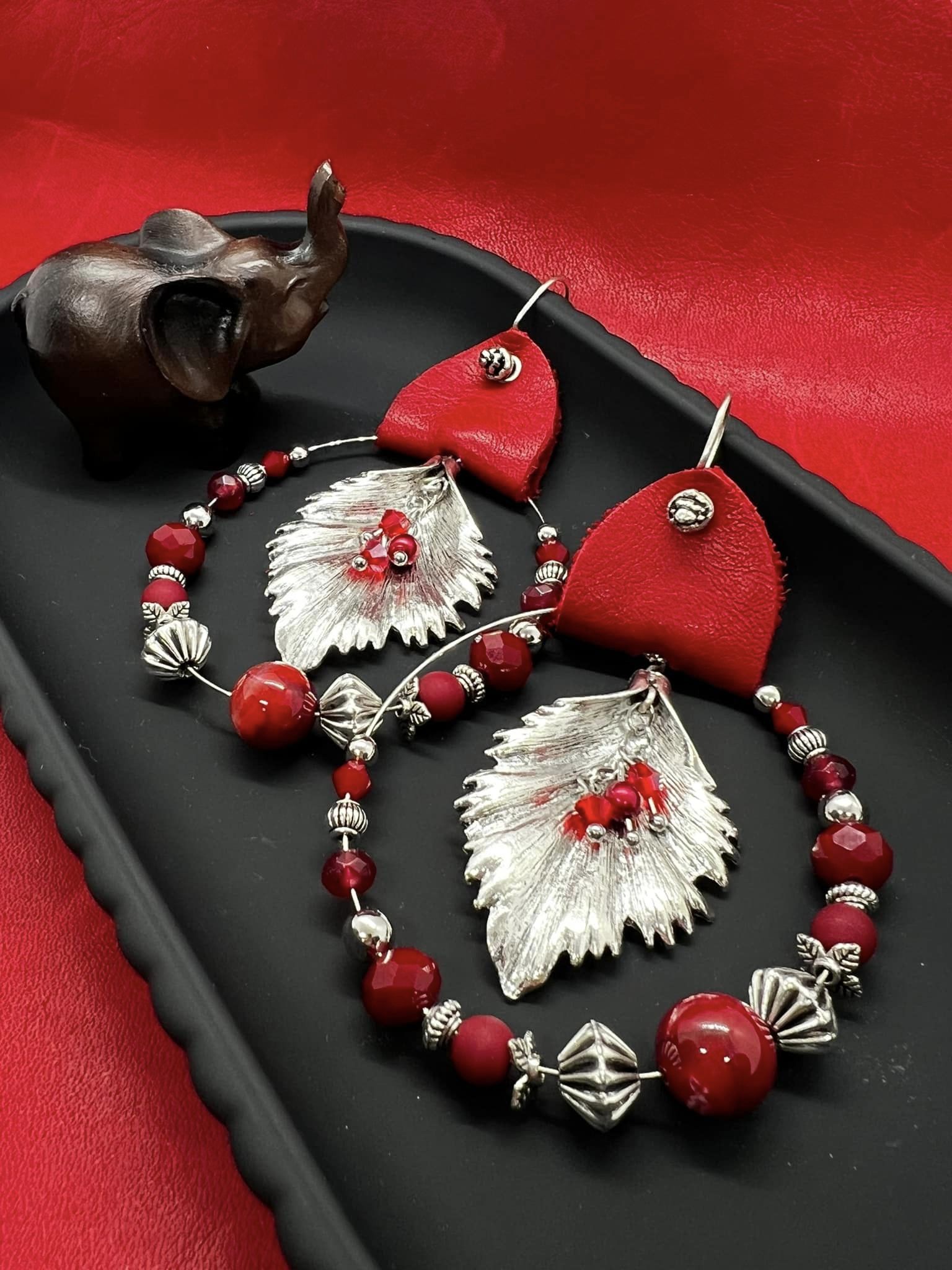 Red and silver beaded earrings with silver feather insert